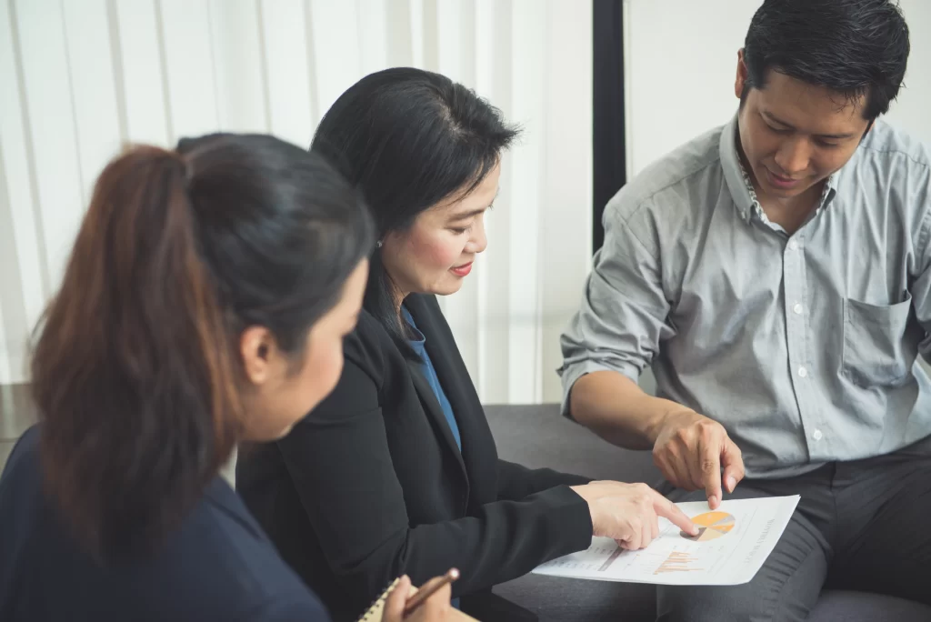 insurance broker explaining coverage options to a business client in the Philippines