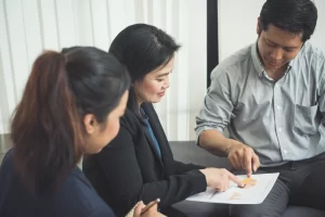 insurance broker explaining coverage options to a business client in the Philippines